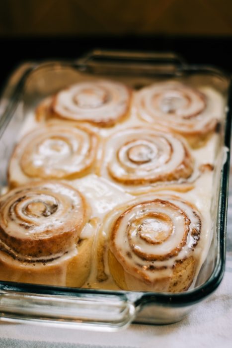 decorative picture of delicious iced cinnamon rolls pulled fresh out of the oven, which you'll be making in this cooking class!