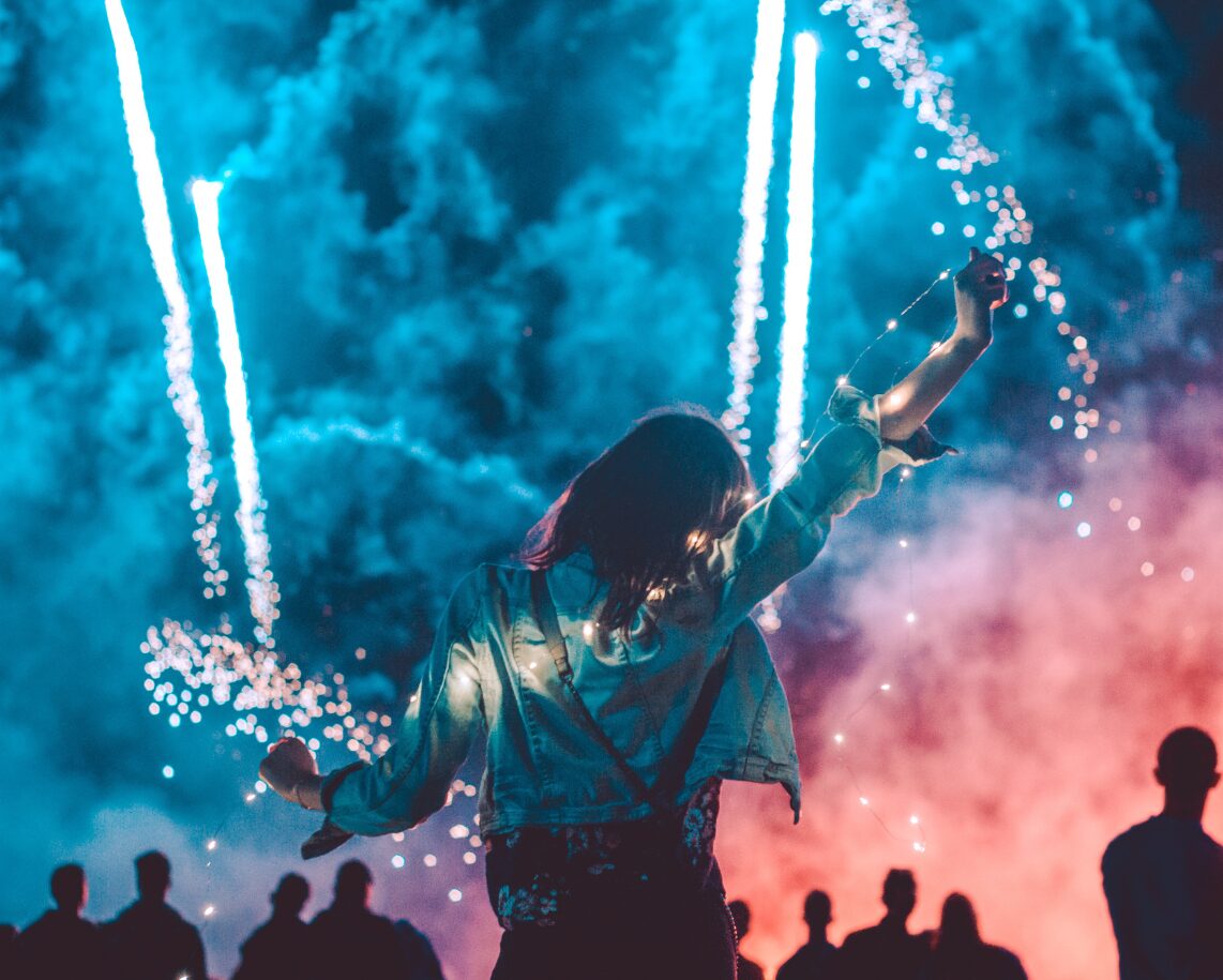 woman in front of fireworks